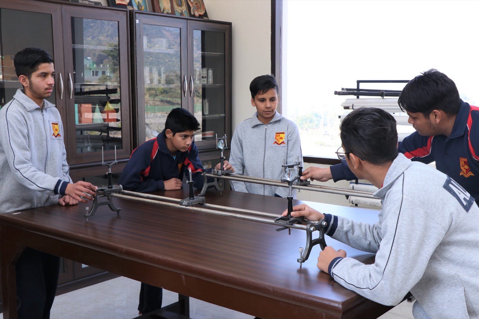 Students conducting an experiment with laboratory apparatus